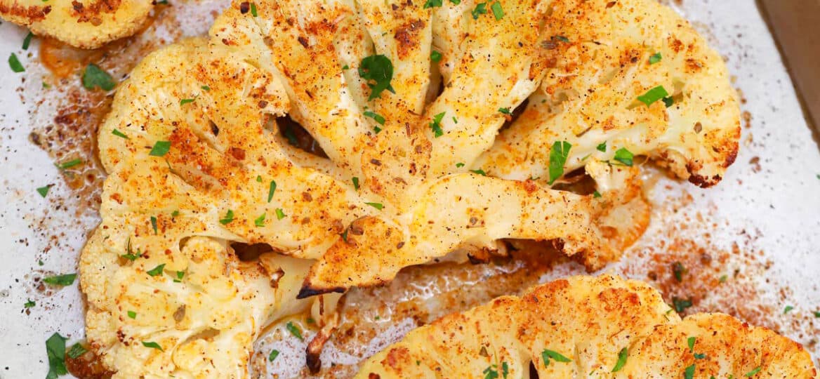 cauliflower steaks on a baking sheet