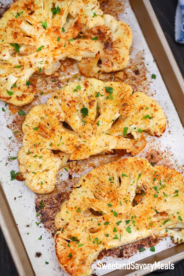 cauliflower steaks on a baking sheet