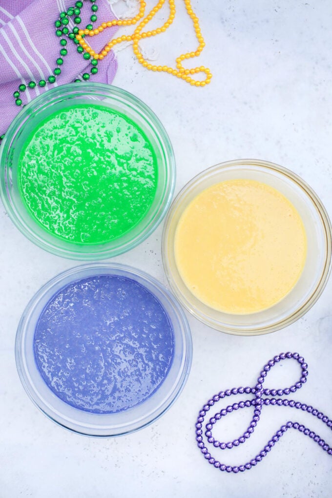 Green, purple, and yellow cake batter.
