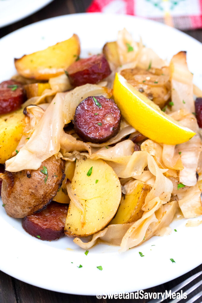 cabbage and sausage with a lemon wedge