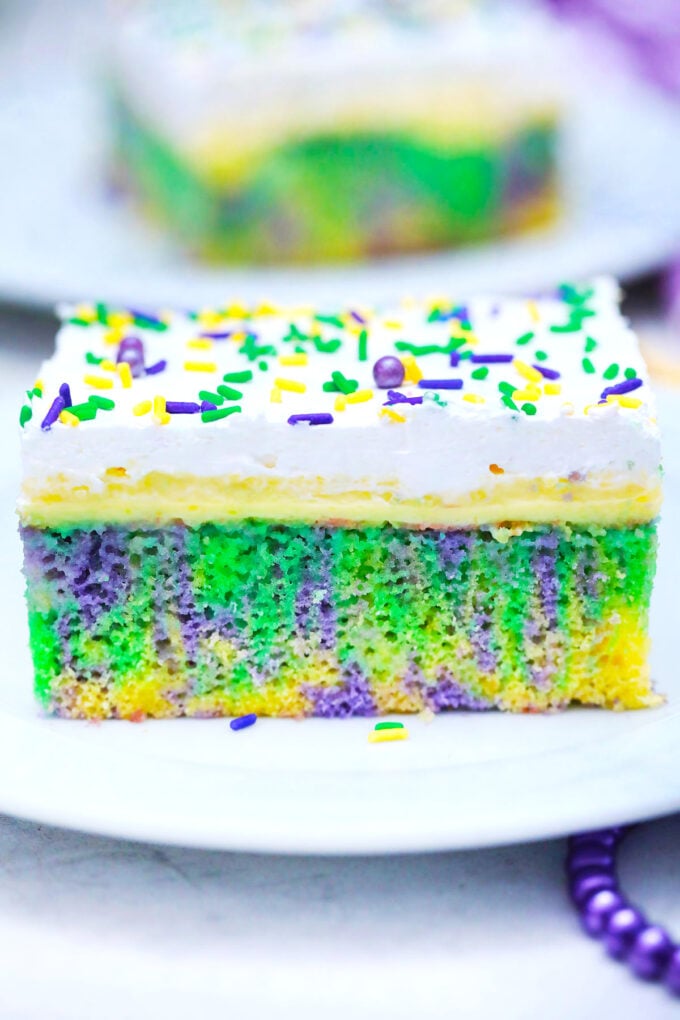 A slice of colorful homemade king poke cake.