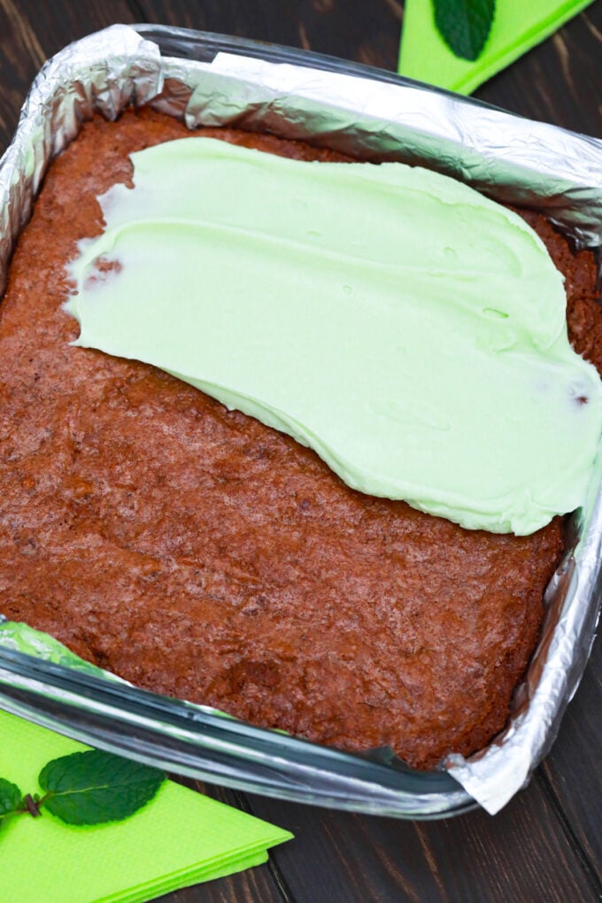 Topping brownies with mint cream cheese frosting.