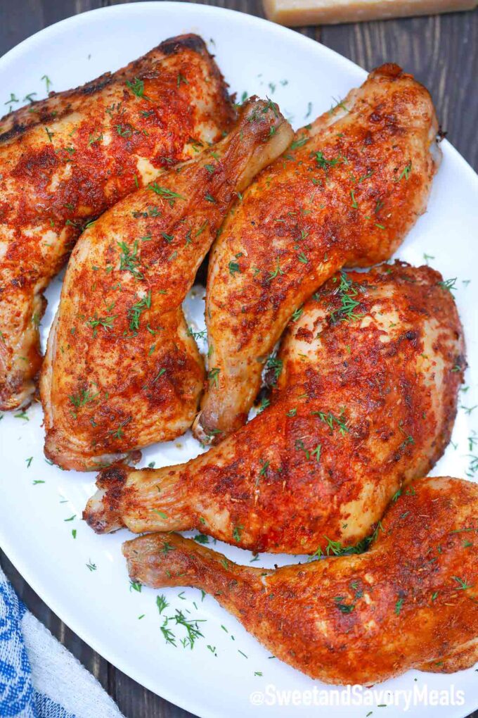 air fryer chicken thighs with seasoning on a serving plate