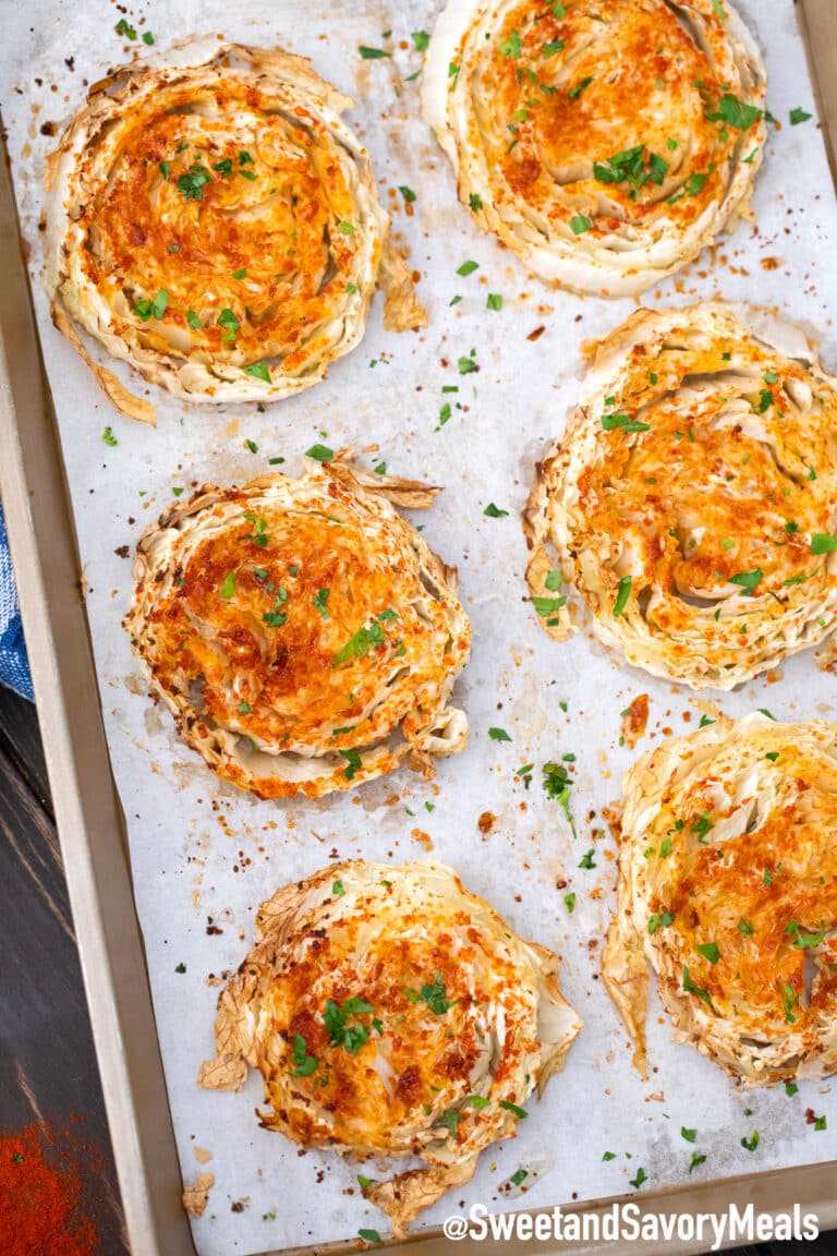 napa cabbage steaks on a baking sheet