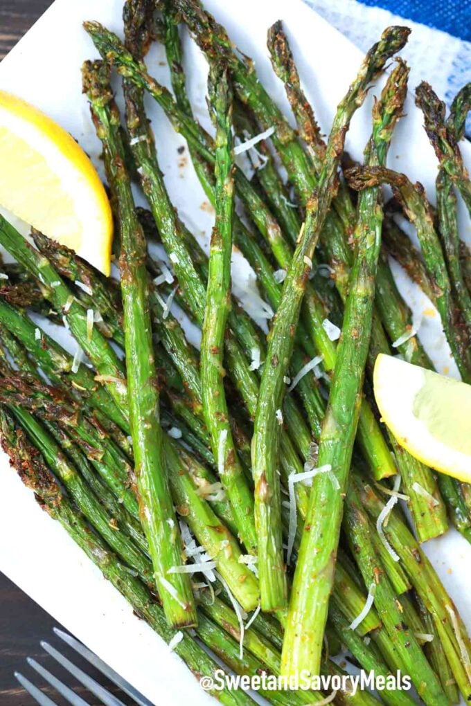 air fryer asparagus with parmesan cheese on a white plate