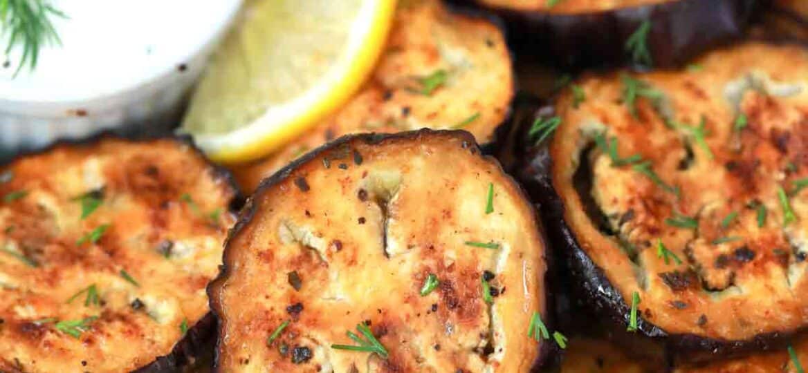 air fryer eggplant on a plate with tzatziki sauce