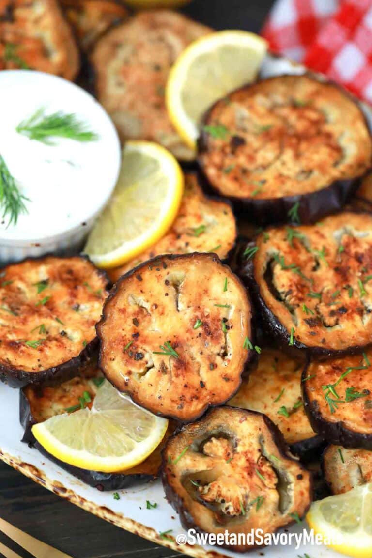 air fryer eggplant on a plate with tzatziki sauce