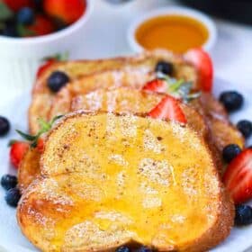 air fryer French toast with honey and berries on a plate