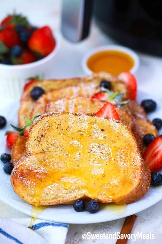 air fryer French toast with honey and berries on a plate