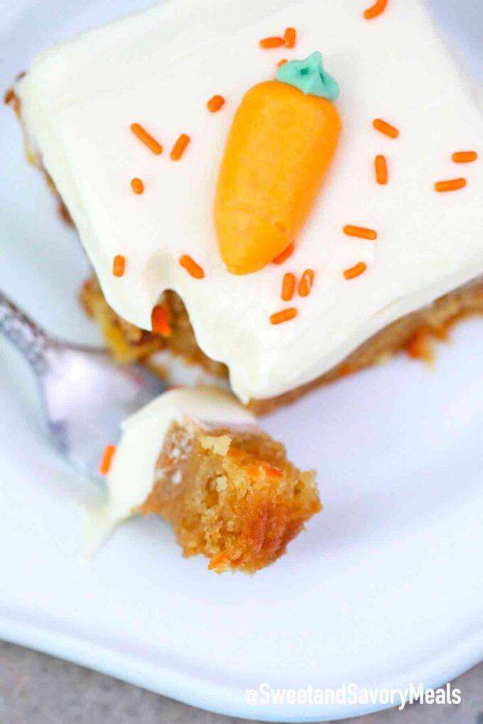 carrot cake bars with cream cheese frosting bit on a fork