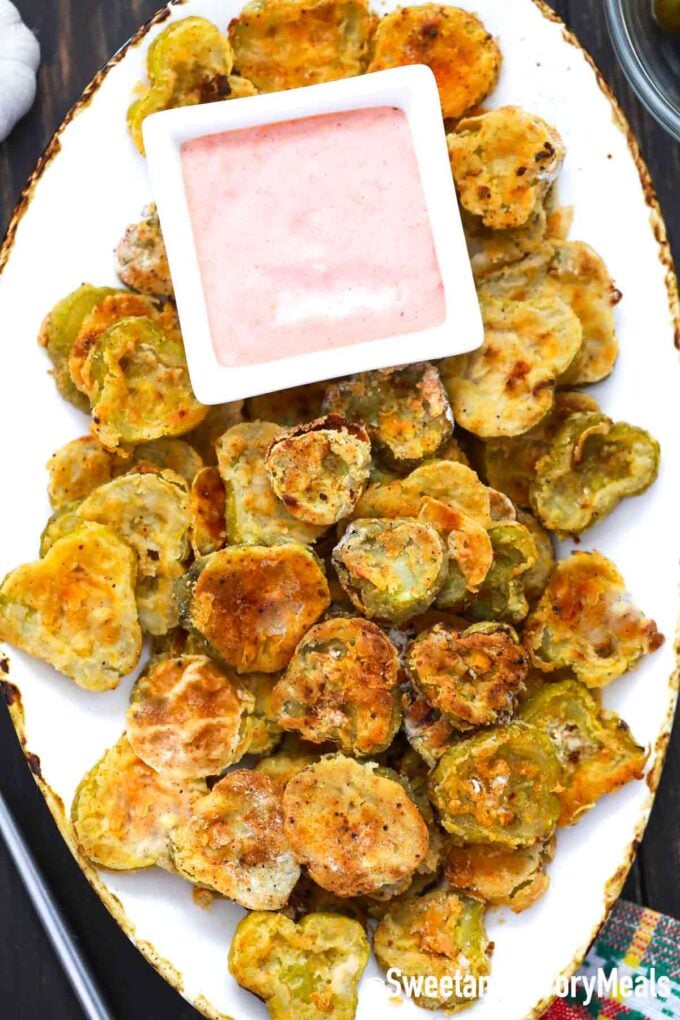 fried pickles on a serving plate with sauce