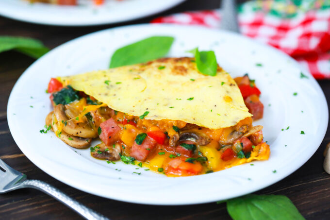 Fluffy and tender omelet with veggies and ham.