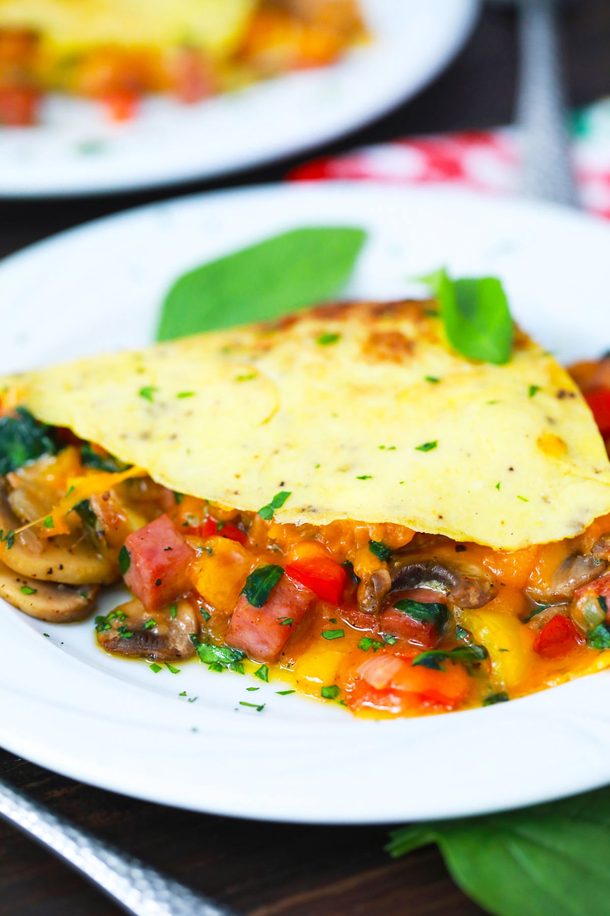 Homemade omelet stuffed with veggies and ham.