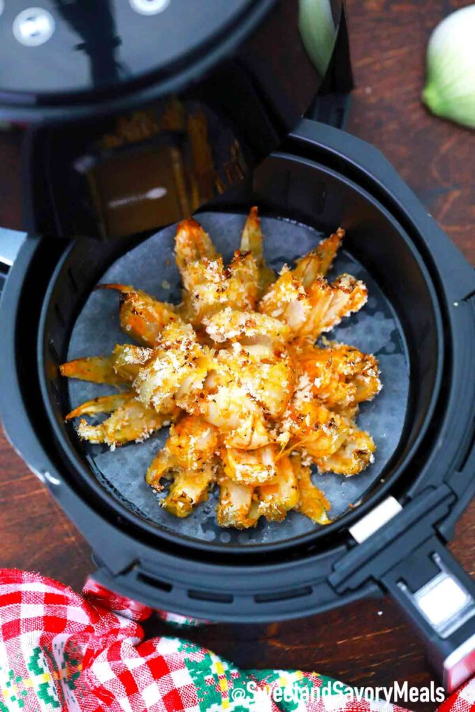 Crispy air fryer blooming onion in an air fryer basket