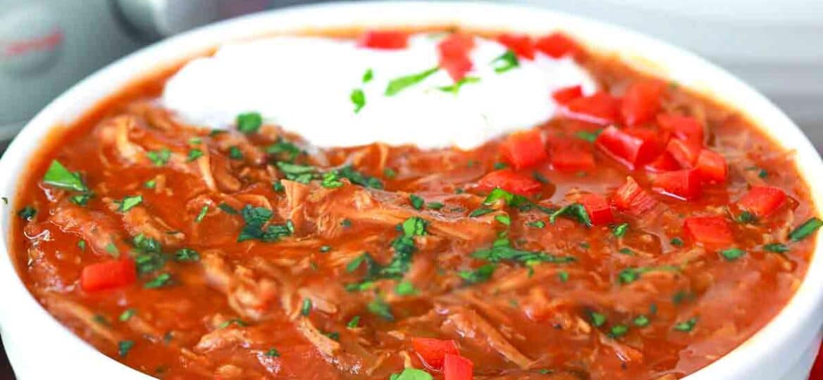 a bowl of instant pot texas brisket chili with sour cream