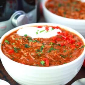 a bowl of instant pot texas brisket chili with sour cream