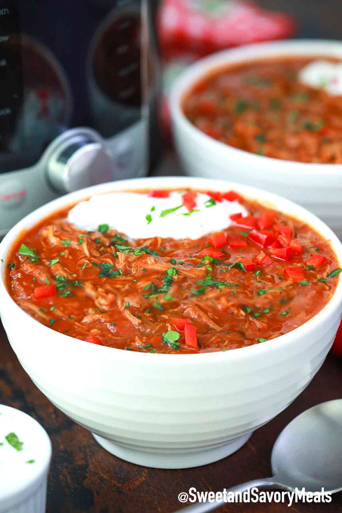 a bowl of instant pot texas brisket chili with sour cream