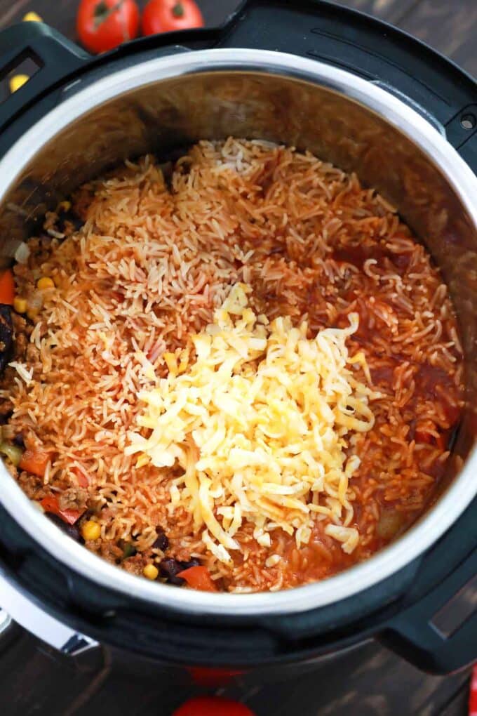 Adding cheese to Instant Pot Mexican casserole.