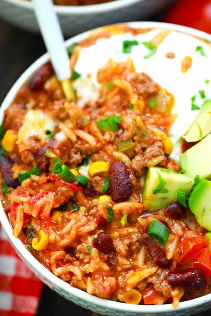 A bowl of Instant Pot Mexican casserole with sour cream and avocado.