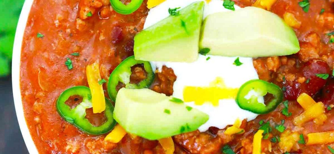 pressure cooker mexican chili topped with avocado sour cream and cheese