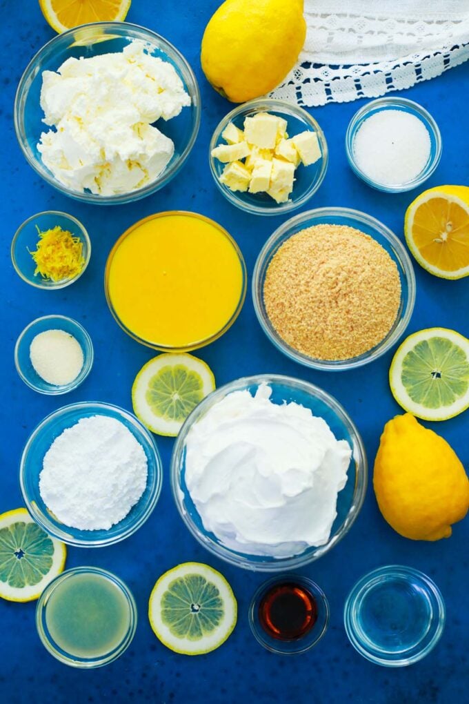 Overhead shot of lemon mousse ingredients in bowls on a table.
