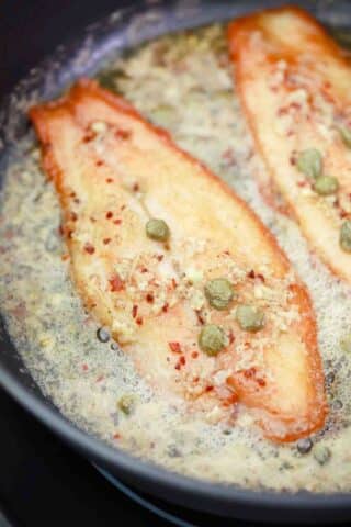 swai fish on melted butter and capers
