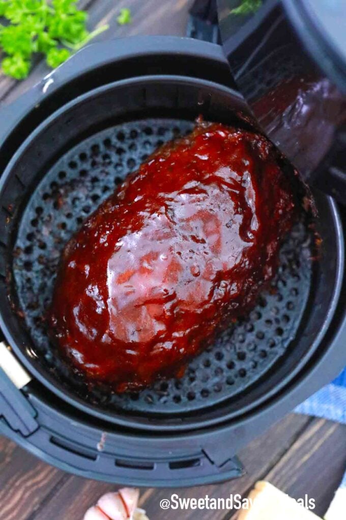 air fried meatloaf in the air fryer basket with ketchup glaze