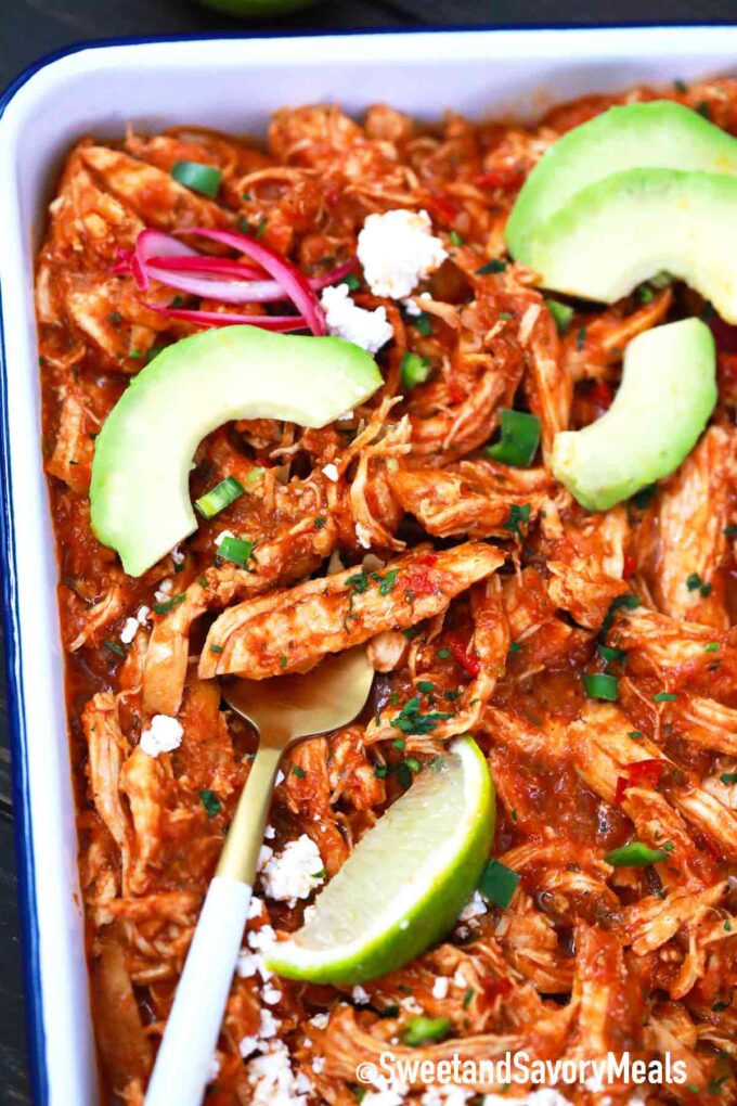 chicken tinga with avocado slices, cotija cheese, lime and red onion