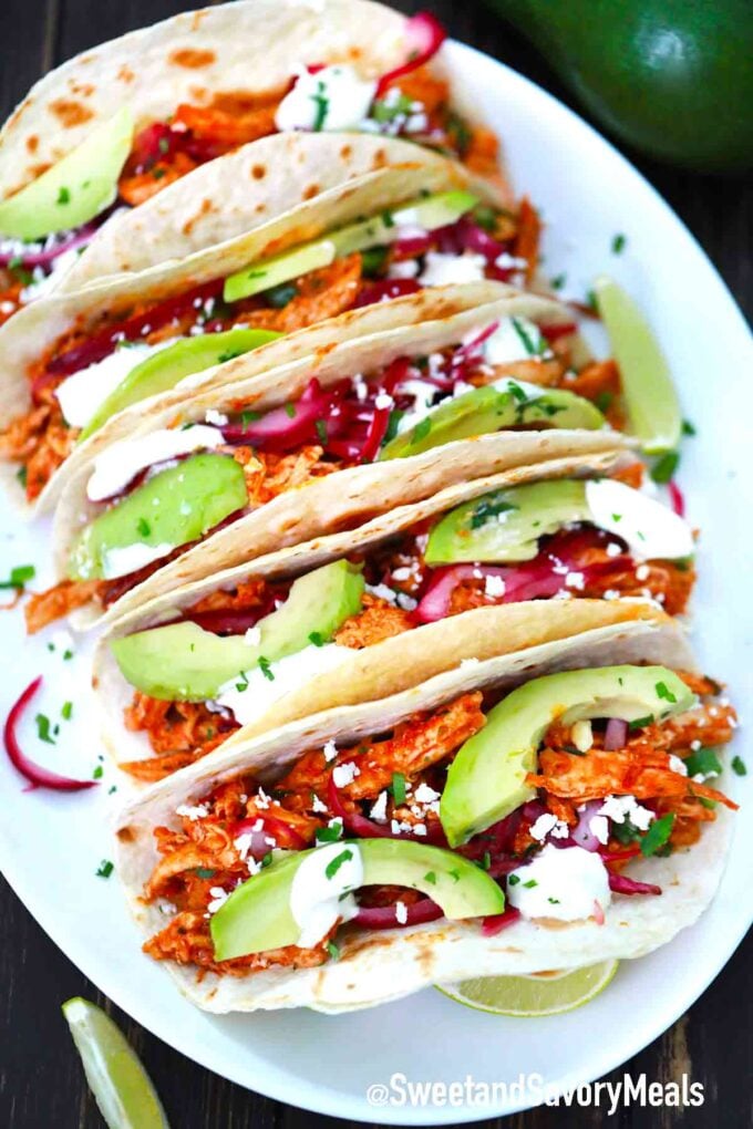 Chicken Tinga tacos on a white serving platter
