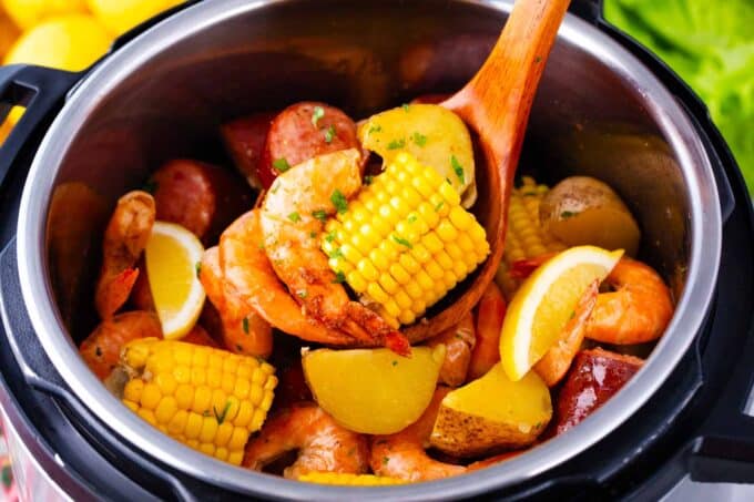An instant pot filled with shrimp boil with sausage and corn.