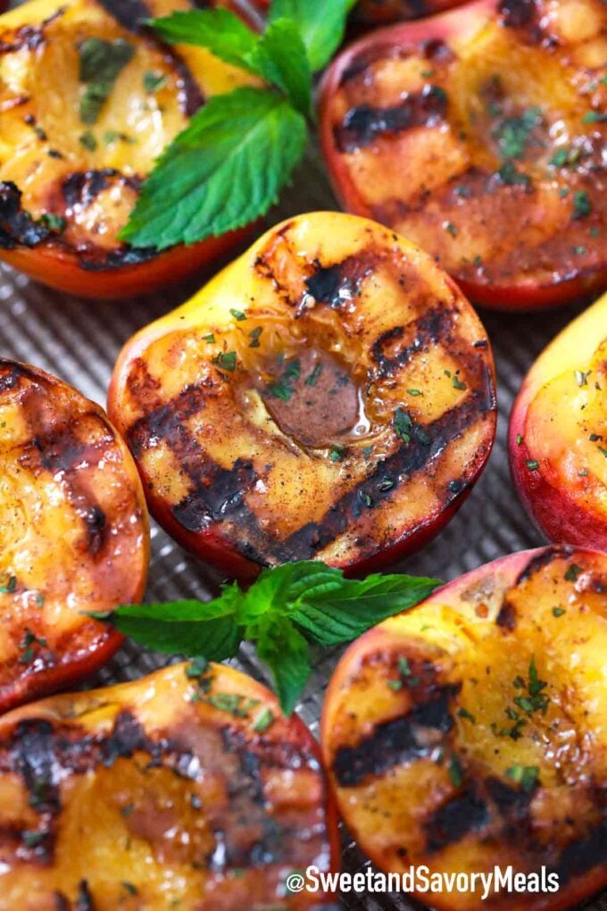 grilled peaches on a baking sheet