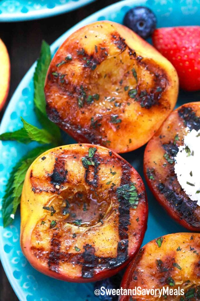 grilled peaches on a blue plate
