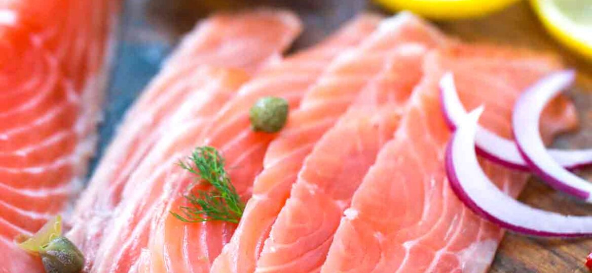 sliced homemade lox on a wooden board