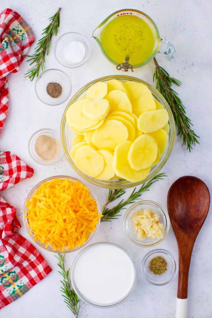 Overhead shot of instant pot scalloped potatoes ingredients in bowls on a table.