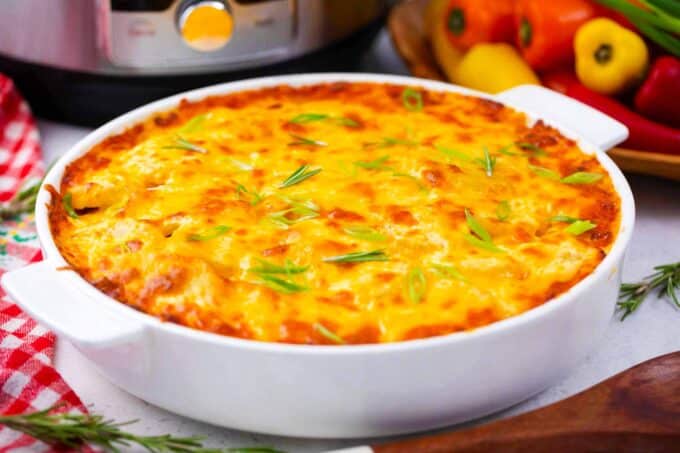 A baking dish with cheesy instant pot scalloped potatoes.