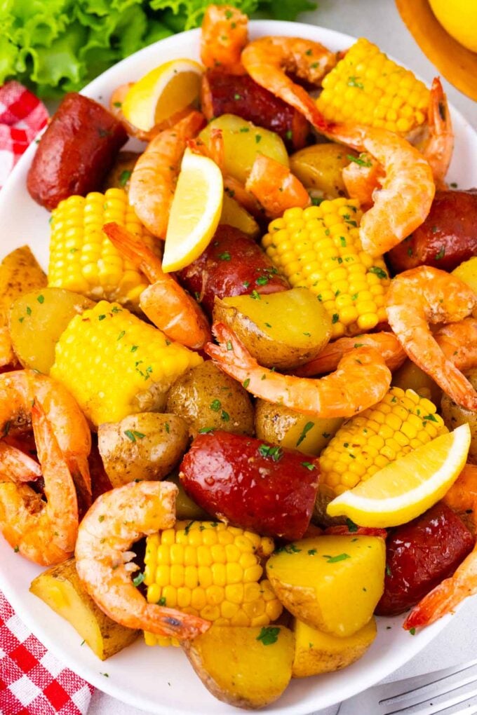 Overhead shot of instant pot shrimp boil with sausage and corn on a serving plate.