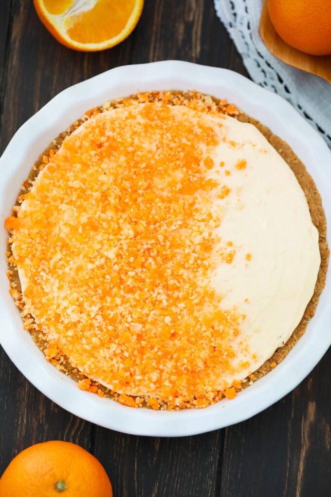 Overhead shot of orange creamsicle pie topped with orange crumbles.