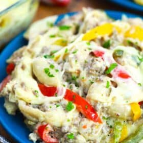 Philly cheesesteak casserole serving on a blue plate