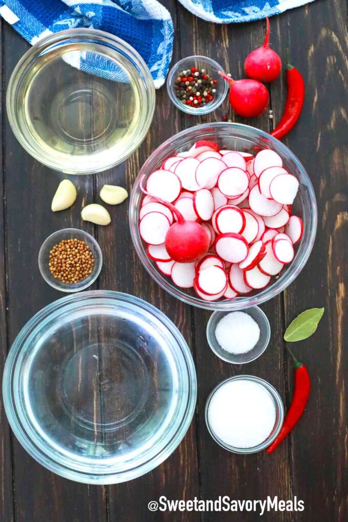 ingredients for pickled radishes on a wooden table