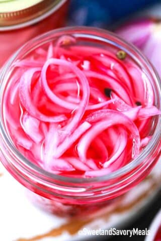 pickled red onions in a glass jar