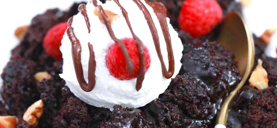 fudgy chocolate cake with ice cream and raspberries