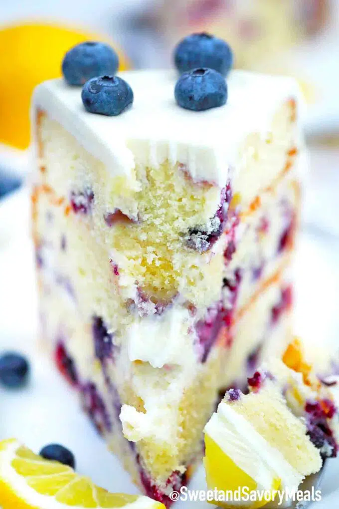 slice of blueberry lemon cake topped with blueberries