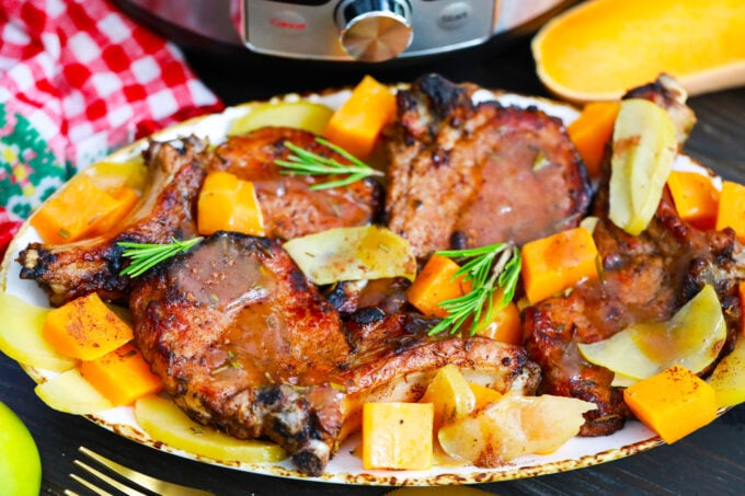Homemade instant pot apple cinnamon pork chops with butternut squash and brown sugar sauce.
