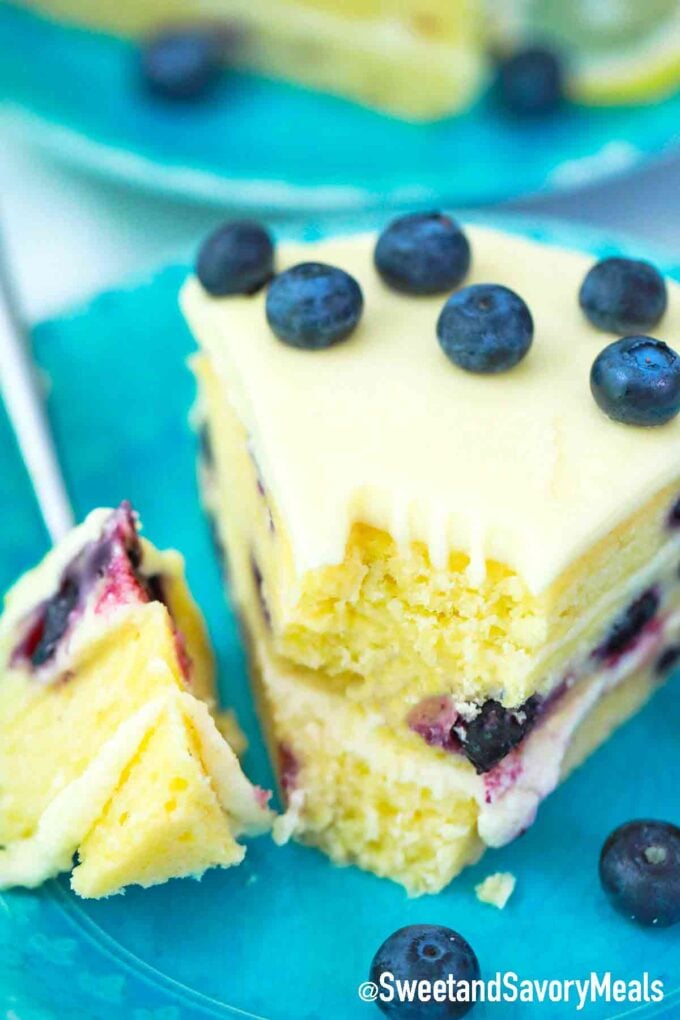 a slice of lemon blueberry cake with blueberry garnish
