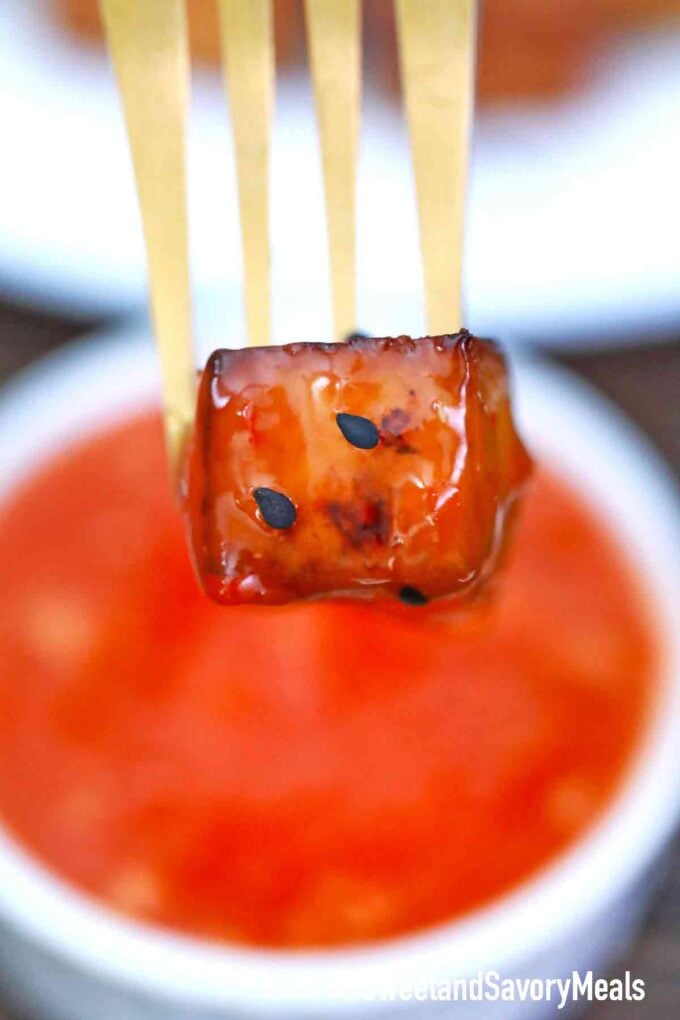 tofu cube dipped in sweet chili sauce