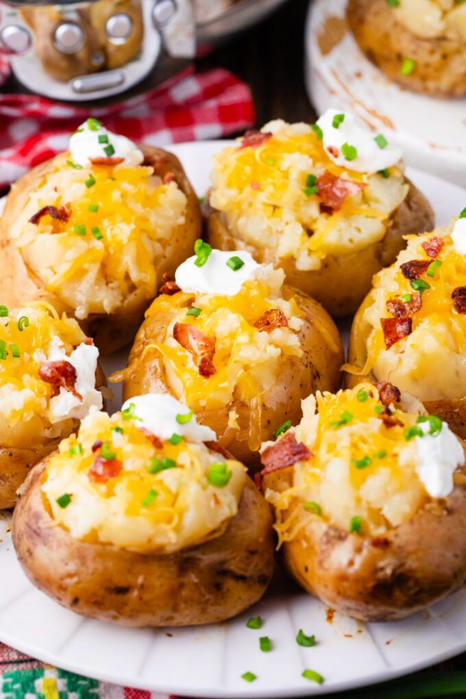 Crockpot baked potatoes topped with cheese and bacon.