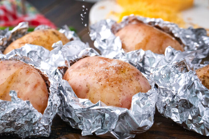 Seasoning potatoes with salt.