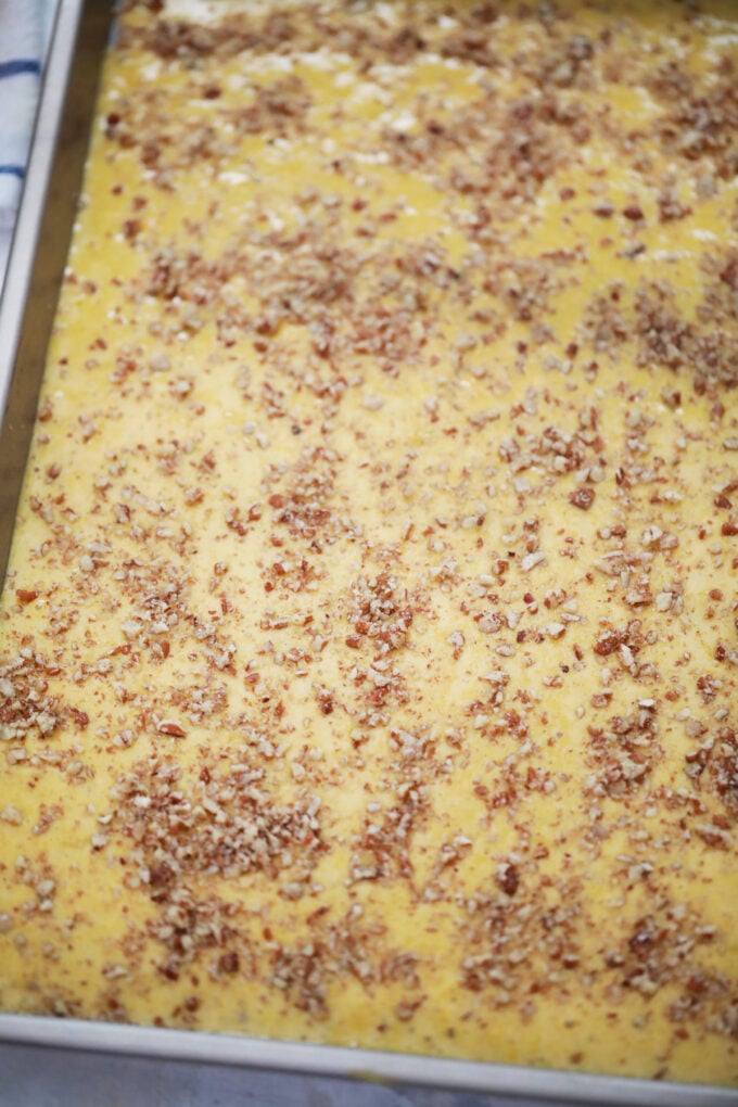 Pumpkin roll batter in a baking sheet.