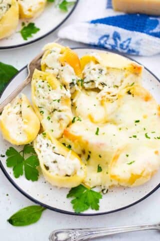 chicken alfredo stuffed shells on a serving plate