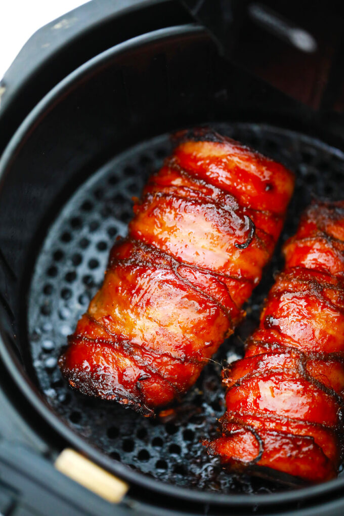 Brown sugar glazed air fryer bacon wrapped pork tenderloin.